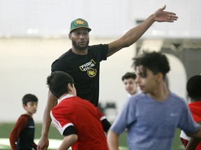 Adarius Bowman, shown here at a flag football clinic in February, is the latest David Boone Memorial Award winner for his work with autistic children. (Larry Wong)
