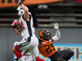 Ottawa Redblacks’ Greg Ellingson (left) and B.C. Lions’ Ronnie Yell collide during their game  at BC Place in Vancouver last night. (The Canadian Press)