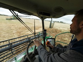 Dave Vander Heide brings in canola behind the wheel of his combine as part of a team of volunteers working with Share the Harvest and the Canadian Foodgrains Bank in a field east of Gibbons, Alberta on Saturday, October 7, 2017. Proceeds from crop sales provide food and farming assistance to people facing poverty around the world. Ian Kucerak / Postmedia
