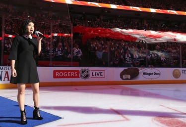 Martina Ortiz-Luis sings the national anthem before the game in Toronto on Saturday October 7, 2017. Jack Boland/Toronto Sun/Postmedia Network