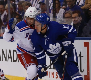 Toronto Maple Leafs�Zach Hyman C (11) and New York Rangers Tony DeAngelo D (77) bump heads in the first period in Toronto on Saturday October 7, 2017. Jack Boland/Toronto Sun/Postmedia Network