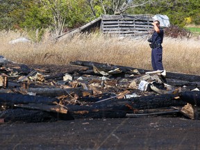 An OPP officer looks over the remains of a barn which burnt to the ground early Sunday morning in Prince Edward County. The cause of the fire is unknown however police say it is considered to be suspicious and is currently under investigation. Police say witnesses saw a four-door sedan type vehicle, beige or taupe in colour, in the area several times prior to the blaze breaking out. The barn did not house any animals and was completely destroyed. Anyone with information on this incident is asked to call the OPP Communications Centre at 1-888-310-1122 or Crime Stoppers at 1-800-222-TIPS (8477).
Tim Miller/Belleville Intelligencer/Postmedia Network