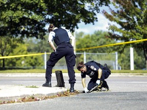 Toronto Police search for evidence following the stabbing death of a man in Stan Wadlow Park in East York. (STAN BEHAL, Toronto Sun)