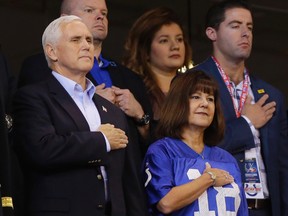 Vice President Mike Pence and his wife, Karen, stand during the playing of the national anthem before an NFL game between the Indianapolis Colts and the San Francisco 49ers, Sunday, Oct. 8, 2017, in Indianapolis. (AP Photo/Michael Conroy)