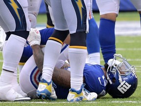 New York Giants wide receiver Odell Beckham grabs his leg after suffering an injury during the second half of an NFL football game against the Los Angeles Chargers, Sunday, Oct. 8, 2017, in East Rutherford, N.J. The Chargers won 27-22. (AP Photo/Bill Kostroun)