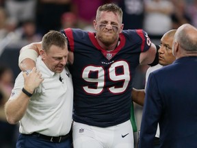 J.J. Watt #99 of the Houston Texans is helped off the field after being injured in the first quarter against the Kansas City Chiefs at NRG Stadium on October 8, 2017 in Houston, Texas. (Photo by Bob Levey/Getty Images)