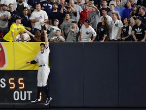 New York Yankees right fielder Aaron Judge makes a catch at the wall on a line drive hit by Cleveland Indians' Francisco Lindor during the sixth inning in Game 3 of baseball's American League Division Series, Sunday, Oct. 8, 2017, in New York. (AP Photo/Frank Franklin II)