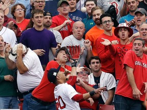 Boston Red Sox right fielder Mookie Betts goes to the wall to catch a fly ball by Houston Astros' Josh Reddick during the second inning of Game 3 of baseball's American League Division Series, Sunday, Oct. 8, 2017, in Boston. (AP Photo/Charles Krupa)