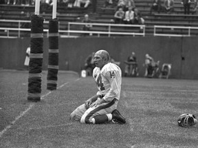 In this Sept. 20, 1964, file photo, New York Giants’ Y.A. Tittle squats on the field after being hit hard while passing during a game against the Pittsburgh Steelers. (AP Photo/Dozier Mobley, File)