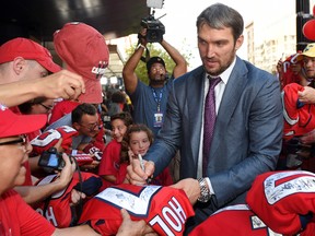 Washington Capitals' Alex Ovechkin signs autographs for fans on the red carpet before an NHL game against the Montreal Canadiens on Oct. 7, 2017. (AP Photo/Nick Wass)