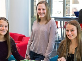 In this photo taken Oct. 2, 2017, from left to right, three of four quadruplets, Rachel, Casey, and Kelly Murphy, pose in Camden, N.J. The quadruplets are working toward careers in medicine like their late mother, Toni Murphy. (Jessica Griffin/The Philadelphia Inquirer via AP)