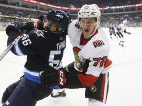 Ottawa Senators' Thomas Chabot checks Winnipeg Jets' Marko Dano during NHL pre-season action in Winnipeg on Sept. 27, 2017. (THE CANADIAN PRESS/John Woods)