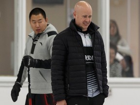 Skip Kevin Koe (right) reacts to a shot in front of Skip Rui Liu during the final between the Koe rink and the Liu rink at the fifth annual Direct Horizontal Drilling Fall Classic at the Crestwood Curling Club in Edmonton, Alberta on Monday, October 9, 2017.