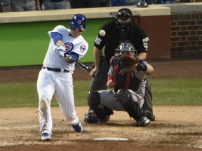 Cubs' Anthony Rizzo hits an RBI single during the eighth inning of Game 3 of the National League Division Series against the Nationals in Chicago on Monday, Oct. 9, 2017. (David Banks/AP Photo)