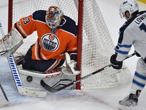 Edmonton Oilers goalie Cam Talbot (33) stops Winnipeg Jets Adam Lowry point blank during second period NHL action at Rogers Place in Edmonton, October 9, 2017.
