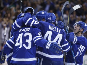 Members of the Toronto Maple Leats celebrate their tying goal in the third period of an eventual 4-3 victory over the Chicago Blackhawks at the Air Canada Centre in Toronto on Oct. 9, 2017. (MICHAEL PEAKE/Toronto Sun)