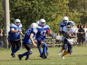 CASS Knights Roje Anderson, right, carries the ball up the field against the Ingersoll District Collegiate Institute Blue Bombers in Woodstock, Ont. on Thursday October 5, 2017 at College Avenue Secondary School during their TVRA Varsity football game. CASS won 44-0. Greg Colgan/Woodstock Sentinel-Review/Postmedia Network.