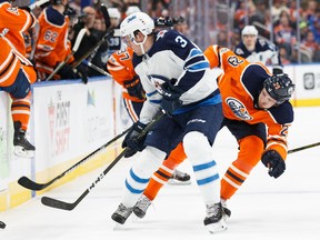EDMONTON, AB - OCTOBER 09: Leon Draisaitl #29 of the Edmonton Oilers battles against Tucker Poolman #3 of the Winnipeg Jets at Rogers Place on October 9, 2017 in Edmonton, Canada. (Photo by Codie McLachlan/Getty Images)
