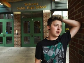 In this undated file photo, Stiles Zuschlag, a transgender teen, stands outside Noble High School in North Berwick, Maine. (Deb Cram/Portsmouth Herald via AP, File)