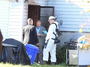 James Allen, a fire investigator with the Ontario Fire Marshal's office speaks with detectives at the scene of a fatal fire in Sudbury, Ont. on Tuesday October 10, 2017. Greater Sudbury EMS, Fire Services and police responded to the blaze just after 8 am on Tuesday morning.Gino Donato/Sudbury Star/Postmedia Network