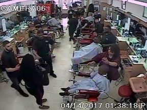 Andrea Smith, 31, is seen in security camera footage putting a gun back into her purse at a Cleveland barber school on April 14, 2017.