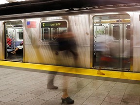 People walk on a subway platform in New York on June 22, 2016.  THE CANADIAN PRESS/AP, Frank Franklin II