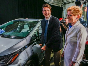 Canadian Prime Minister Justin Trudeau along with Ontario Premier Kathleen Wynne plug in a Chev. Bolt electric car as they were on hand at the Oshawa General Motors Plant to announce 1,000 new jobs across Ontario on June 10, 2016.