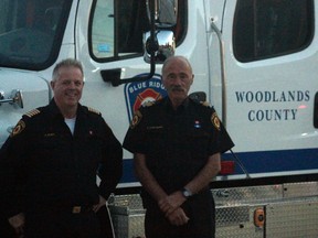 Blue Ridge Fire Chief Gerry Bizier (left) and deputy chief Kaj Christensen stand next to a new fire truck their department recently received (Joseph Quigley | Mayerthorpe Freelancer).