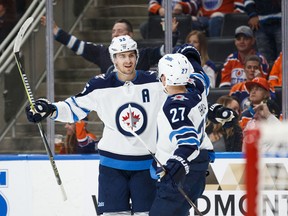 EDMONTON, AB - OCTOBER 09: Mark Scheifele #55 and Nikolaj Ehlers #27 of the Winnipeg Jets celebrate Ehlers' hat trick against the Edmonton Oilers at Rogers Place on October 9, 2017 in Edmonton, Canada. (Photo by Codie McLachlan/Getty Images)