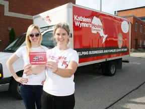 JOHN TAPLEY/SENTINEL REVIEW
Christine Van Geyn, Ontario director with the Canadian Taxpayers' Federation, and Brittany Allison, tour director, display one of the postcards being handed out for people to sign as they take the Federation's satirical Kathleen Wynne's Moving Company truck around the province. The public awareness and engagement campaign is aimed at drawing attention to government policy that has led to higher electricity costs, cap and trade and pending minimum wage hikes.