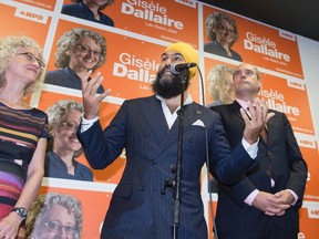 NDP Leader Jagmeet Singh, centre, responds to reporters questions during a campaign visit for local candidate Gisele Dallaire, left, Tuesday, October 10, 2017 in Alma, Quebec. THE CANADIAN PRESS/Jacques Boissinot