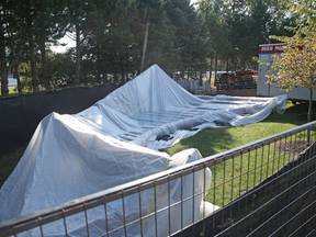 Part of Jill Anholt's sculpture Moving Surfaces sits under a tarp at Lansdowne Park. JEAN LEVAC / POSTMEDIA NETWORK