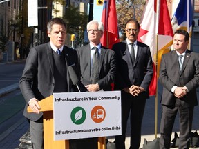 Winnipeg Mayor Brian Bowman speaks about new federal infrastructure money for Winnipeg on Tuesday, Oct. 10. 2017, as federal Natural Resources Minister Jim Carr (centre), federal Infrastructure Minister Amarjeet Sohi (centre right) and Manitoba Municipal Relations Minister Jeff Wharton (far right) look on. JOYANNE PURSAGA/Winnipeg Sun/Postmedia Network