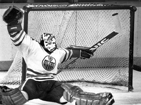 Edmonton Oilers goalie Grant Fuhr makes a great save off of a Minnesota North Stars player as the puck passes the right post during third round NHL playoff action at the Northlands Coliseum in Edmonton on April 26, 1984. Edmonton Sun/QMI Agency