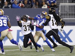 Tiger-Cats' Richard Leonard (37) can’t hang on to a pass intended for Blue Bombers' Ryan Lankford on the weekend. (The Canadian Press)