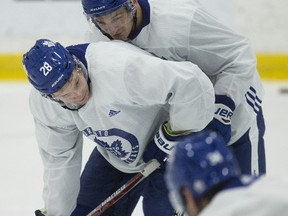 Zach Hyman (top) gets up close and personal with fellow forward Connor Brown as the Leafs worked out on Oct. 10, 2017. .(CRAIG ROBERTSON/Toronto Sun)