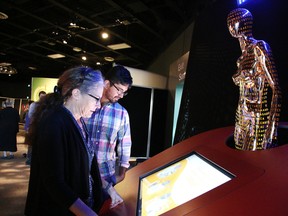 Leslie Sutherland and Jose Knee, both scientists at Health Sciences North Research Institute, check out the launch of Science North's new state-of-the-art exhibition about genomic science, Genome: Unlocking Life's Code in Sudbury, Ont. on Tuesday October 10, 2017. The exhibit opens  for the first time in Canada at Science North. It will be at Science North until Jan. 7, 2018. Gino Donato/Sudbury Star/Postmedia Network