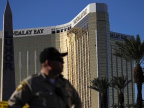 In this Tuesday, Oct. 3, 2017 file photo, a Las Vegas police officer stands by a blocked off area near the Mandalay Bay casino in Las Vegas. (AP Photo/John Locher, File)
