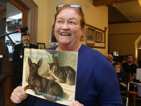 Jason Miller/The Intelligencer
Glanmore National Historic Site curator Rona Rustige displays a book of Horatio Couldery's animal art on display at Glanmore, which houses a collection of paintings by Couldery.  The book was produced as a fundraising initiative by the Friends of Glanmore. During the 1950s, the family of his brother, Bertram, donated 42 of Horatio’s paintings to Belleville. About half depict cats.