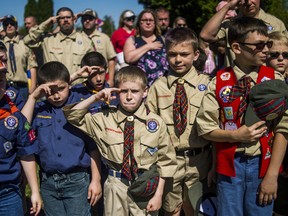 In this Monday, May 29, 2017 file photo, Boy Scouts and Cub Scouts salute during a Memorial Day ceremony in Linden, Mich. (Jake May/The Flint Journal - MLive.com via AP)