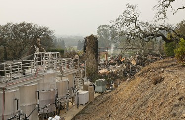 Fermentation tanks still stand next to the burned remains of the Signorello Estate winery Tuesday, Oct. 10, 2017, in Napa, Calif. Worried California vintners surveyed the damage to their vineyards and wineries Tuesday after wildfires swept through several counties whose famous names have become synonymous with fine food and drink. (AP Photo/Eric Risberg)