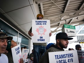 Striking workers are seen picketing near Swissport's administrative offices at Pearson International Airport in Toronto on Friday, July, 28, 2017. THE CANADIAN PRESS/Christopher Katsarov