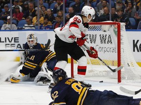 New Jersey Devils forward Jesper Bratt (63) scores on Buffalo Sabres goalie Chad Johnson (31) during the second period of an NHL hockey game, Monday Oct. 9, 2017, in Buffalo, N.Y. (AP Photo/Jeffrey T. Barnes)