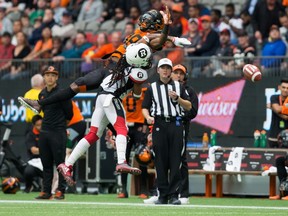 B.C. Lions' Shaq Johnson, back, fails to make the reception as Ottawa Redblacks' Sherrod Baltimore defends during a CFL game in Vancouver on Oct. 7, 2017. (THE CANADIAN PRESS/Darryl Dyck)