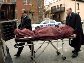 The body of 34-year-old Diana Keeney is brought out of a home at 251 Percy Street in Ottawa in October 2004.