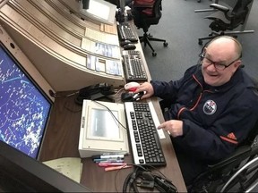 Cam Tait is all smiles as he takes a turn at the air traffic control desk at the Edmonton International Airport. (SUPPLIED)