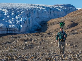 A Parks Canada staff member hikes near Air Force Glacier with the Google trekker in Quttinirpaaq National Park in Nunavut in a handout photo. THE CANADIAN PRESS/HO-Google-Parks Canada-Ryan Bray