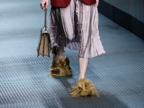In this Wednesday, Jan. 25, 2015 file photo, a model wears footwear with wisps of fur as part of the Gucci women's Fall-Winter 2015-2016 collection, in Milan, Italy. Gucci has become the latest fashion house to eliminate animal fur from its collections, starting with the spring-summer 2018 season. The Humane Society, which supports the fur free alliance among fashion houses, said Gucci’s announcement Wednesday was a ‘’game-changer,’’ involving ‘’perhaps the biggest fur-free retailer announcement worldwide to date.’’ Gucci CEO Marco Bizzarri said the brand would no longer ‘’use, promote or publicize animal fur,’’ beginning with the menswear collection to be previewed in January and womenswear in February. Gucci said it would auction off the remaining fur animal items, with proceeds to benefit LAV and the Humane Society. (AP Photo/Antonio Calanni, File)