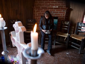 In this Aug. 18, 2017 photo, Juana Pedraza sits beside an altar to her 29-year-old daughter, Jessica, inside the family's home in Villa Cuauhtemoc, Mexico state. (AP Photo/Rebecca Blackwell)