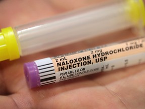 A Rockford firefighter displays a dose of Naloxone which the department carries on their ambulances to treat opioid drug overdoses on July 14, 2017 in Rockford, Illinois.(Photo by Scott Olson/Getty Images)